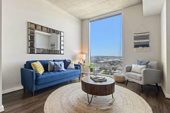 a living room with a blue couch and a round coffee table